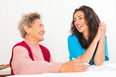 happy senior woman and caregiver