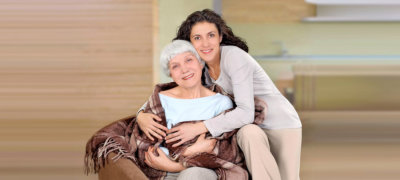 caregiver hugging senior woman